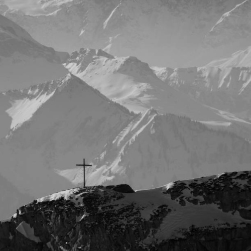 Summit cross on top of Mount Matthorn. Scene in Central Switzerland.