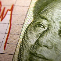 Stock Market Graph next to a Chinese banknote (showing Mao). Red downtrend indicates the stock market recession period